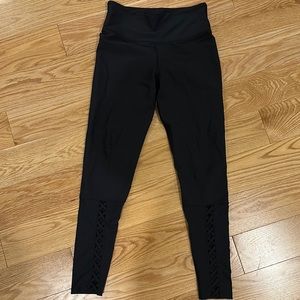Black leggings with cute crosses in front, soulcycle brand